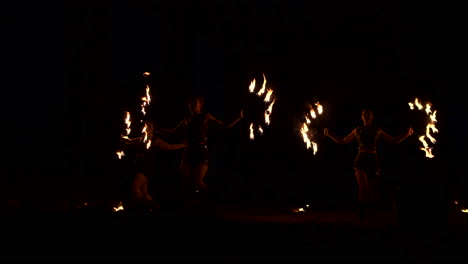 Group-of-fire-jugglers.-People-spit-fire-in-a-dark-night-outdoors-performance.